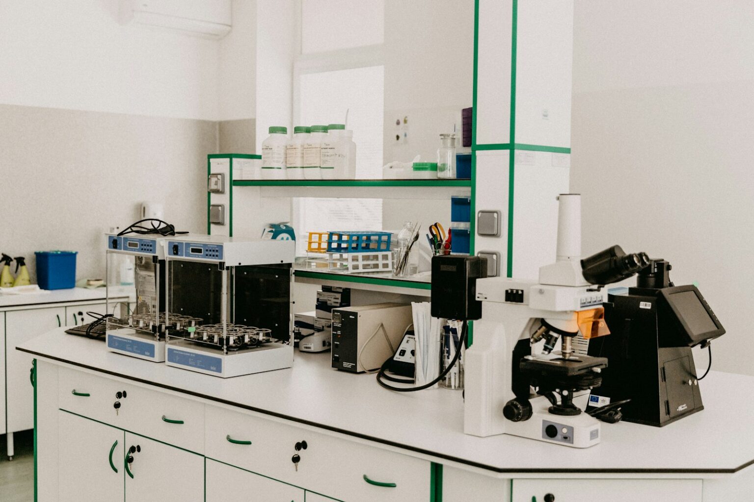 A laboratory workbench with a microscope and analytical equipment