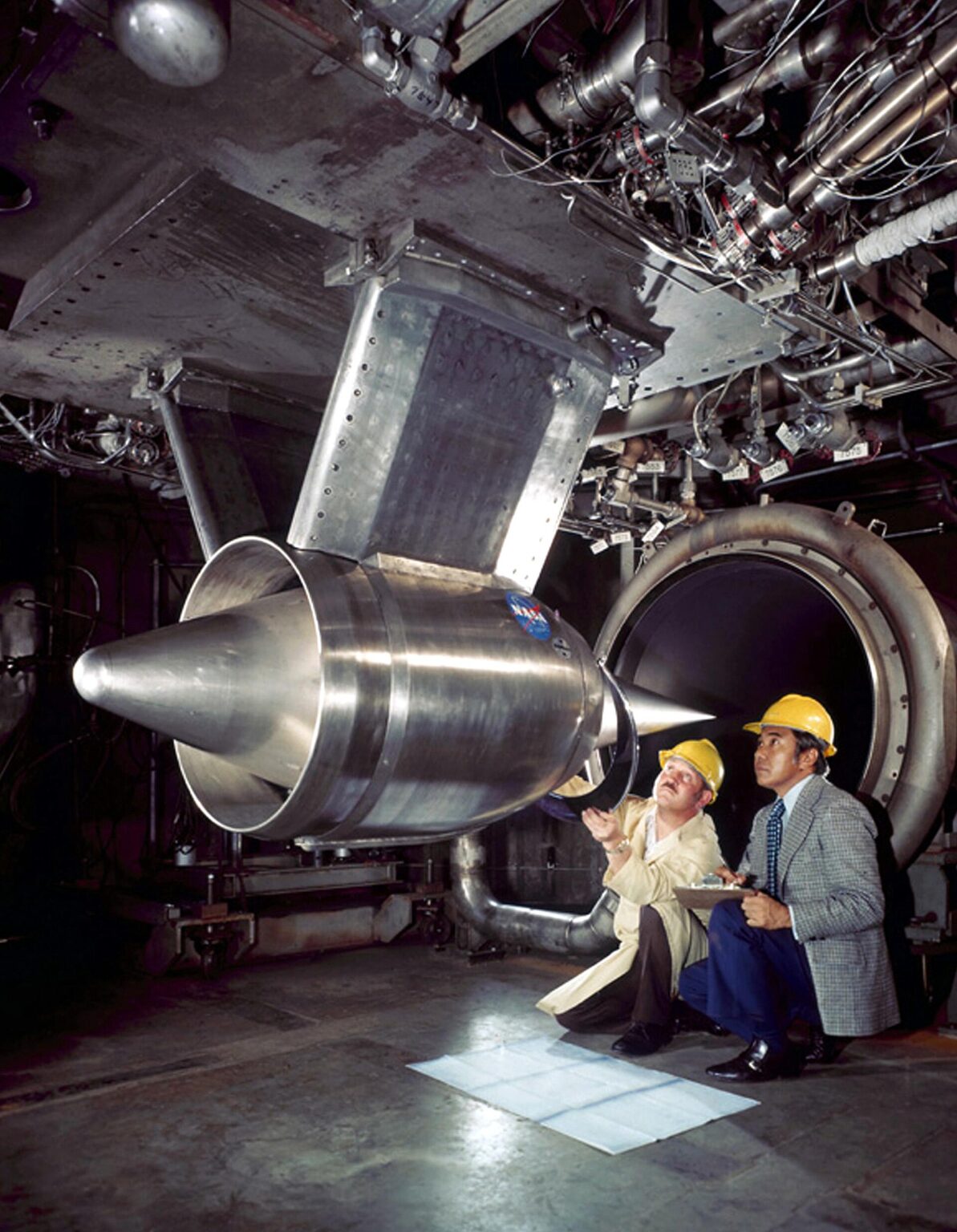 Engineers inspect the inlet of a prototype NASA Hypersonic Research Engine before a test run in 1973