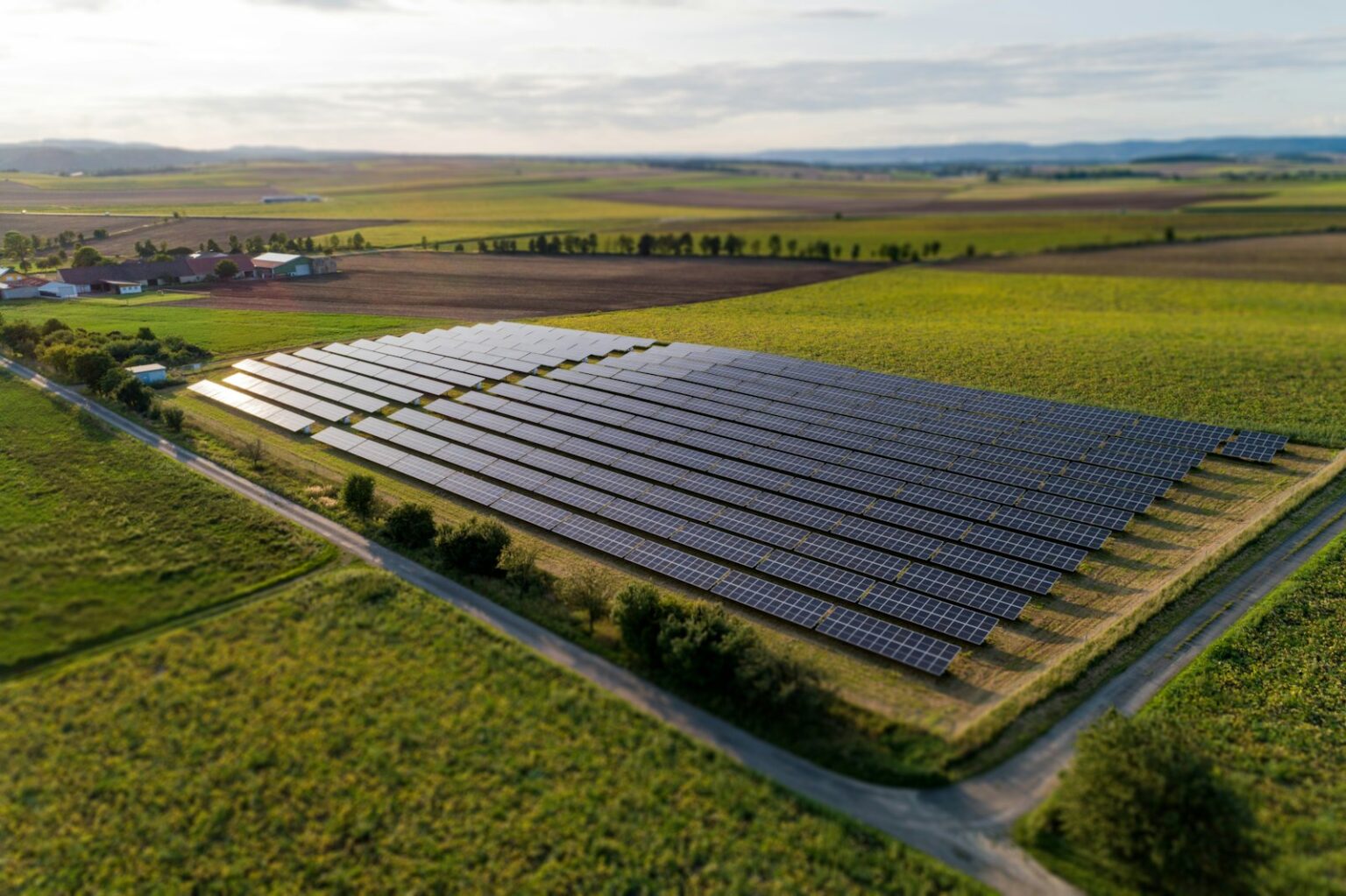 Black solar panels on a green grass field